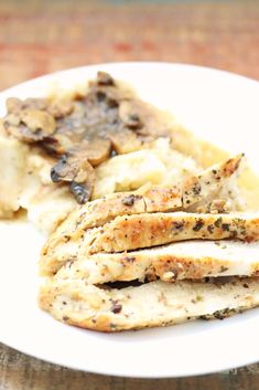 a white plate topped with chicken and mashed potatoes