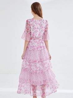 "Bathed in the soft blush of cherry blossoms, this enchanting tiered dress is a hymn to springtime romance. The delicate floral print weaves a narrative of blooming gardens and whispered tales of first love. Its graceful round neckline and sheer, breezy half-sleeves suggest an air of both demure charm and understated elegance. Cinched at the waist with an ornate rose buckle belt, the dress cascades down in ruffled layers, creating an ethereal sway with every step. This dress doesn't just capture Elegant Brunch, Printing Skirt, Leaf Cake, Chiffon Floral Dress, Springtime Wedding, Romantic Aesthetic, Cake Skirt, Wildflower Meadow, Sleeveless Dresses Casual