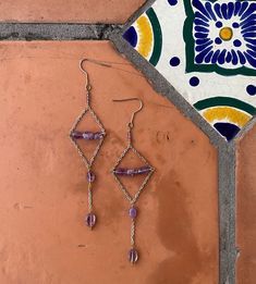 Stainless steel ear hook, chain, brass wire beading, featuring three different amethyst stones bead sizes. Metal Beaded Chain Dangle Earrings, Wire Wrapped Brass Chandelier Dangle Earrings, Wire Wrapped Metal Chandelier Earrings, Wire Wrapped Brass Chandelier Earrings, Bohemian Amethyst Chandelier Earrings Gift, Purple Pierced Metal Jewelry, Purple Metal Pierced Jewelry, Wire Wrapped Amethyst Drop Earrings, Purple Teardrop Metal Jewelry