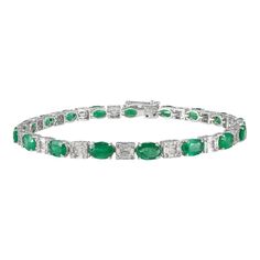 This is part of Chairish’s Fine Jewelry assortment.  This Natural Emerald and Diamond Tennis Bracelet in 18K gold showcases 17 endlessly sparkling natural emerald, weighing 6.64 carat and 170 pieces of diamonds weighing 1.57 carat. It measures 7 inches long in length.  Emerald enhances intellectual capacity of the person. Designed with perfect oval cut emerald with cluster diamonds in after each emerald to make you stand out on any occasion or event. The elegant style complements the attire beau Green Diamond Bracelet For Formal Occasions, Formal Emerald Diamond Bracelet With Brilliant Cut, Luxury Green Brilliant Cut Diamond Bracelet, Formal Emerald Cut Diamond Bracelet, Formal Emerald Diamond Bracelet, Luxury Green Tennis Bracelet For Formal Events, Emerald Diamond Bracelet In White Gold For Formal Events, Luxury Emerald Cut Green Diamond Bracelet, Formal White Gold Diamond Bracelet With Emerald