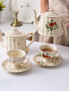 a tea set with two cups and saucers