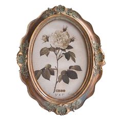 an antique frame with a white rose on it