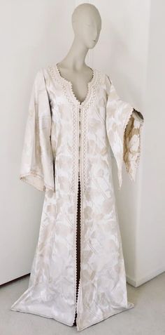 For Sale on 1stdibs - Elegant Moroccan white ivory and old brocade kaftan embroidered with gold trim threads. Size L to XL circa 1980s. This long maxi dress kaftan is embroidered Middle Eastern Outfits Women, Festive Cream Kaftan With Resham Embroidery, Cream Kaftan With Resham Embroidery For Festive Occasions, Cream Resham Embroidery Kaftan For Festive Occasions, Elegant White Floor-length Kimono, Festive White Kaftan With Resham Embroidery, White Silk Kaftan For Festive Occasions, Silk Kaftan With Floral Embroidery For Wedding, Embroidered Silk Maxi Length Kaftan