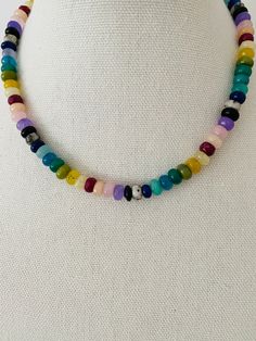 This necklace is a vibrant and eye-catching piece of jewelry that features colorful rondelle beads in a rainbow spectrum of shades. The necklace measures approximately 17 inches in length and can be adjusted to a shorter length, allowing for a customized fit. The rondelle beads are small, cylindrical-shaped beads that have been faceted to catch and reflect light, enhancing their brilliance and adding a touch of sparkle to the necklace. The beads are arranged in a rainbow pattern, with each color Rainbow Spectrum, Colorful Gemstones, Colorful Rainbow, Rainbow Pattern, A Rainbow, How To Make Beads, Gemstone Colors, Beaded Necklace, Sparkle