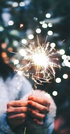 a person holding a sparkler in their hand