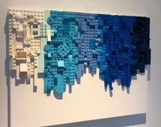 a white wall with blue and green legos on it