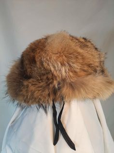 Beautiful vintage fur hat in light warm brown , caramel hue  Fully lined, feels well made and of good quality Lined inside Made in Sweden mark Great vintage condition, no visible flaws. Ready to wear. ● Era : 1950s to 60s ● Label : no label ● Country of origin : SWEDEN ● Fabric composition : natural fur ● How it fits : no stretch ● Condition : very good ●  Measurements  inner circumference approx 56 cm    I always strongly recommend  to check the measurements of a similar well fitting garment from Your own wardrobe for the most accurate sizing, because sizing in different countries / different eras may vary. I only ship with registered tracked economy mail.  I ship from Europe I tend to ship as soon as I can, within 1 to 3 working days. Thank you for choosing vintage and happy shopping! Brown Hats With Ear Flaps For Cold Weather, Brown Hat With Faux Fur Lining And Ear Flaps, Brown Hats With Faux Fur Lining And Ear Flaps, Brown Ear Flaps Hat For Cold Weather, Brown Brimmed Cloche Hat For Winter, Winter Faux Fur Mink Hat, Brown Faux Fur Hat With Ear Flaps, Brown Winter Hat With Faux Fur Lining, Mink Color Hat With Faux Fur Lining For Winter