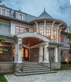 a large house with stone and wood accents