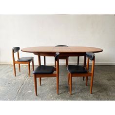 a wooden table with four chairs around it