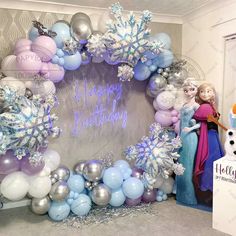 a frozen princess birthday party with balloons and decorations on the wall, including an ice queen balloon arch