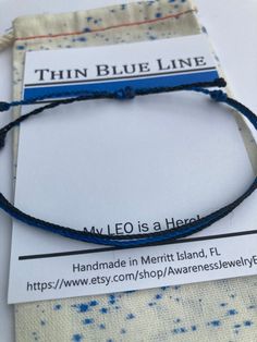 POLICE WIFE BRACELETS -  PURA-VIDE STYLE STRING BRACELET  Need an inexpensive gift for your favorite Police Officer or LEO family member? A BLUE LINE STRING BRACELET IS THE PERECT GIFT. Red line finished examples are shown until I take photos of Blue Line. **String Bracelets are ONE SIZE FITS MOST - If you need XS or XL let me know in notes. PRODUCT DESCRIPTION/MATERIALS Waxed-Polyester Adjustable String Bracelet CARE INSTRUCTIONS **Waterproof > Ok to wear 24-7 **Remove bracelet if working in ya Blue Adjustable Cord Bracelet Gift, Blue Adjustable Cord Bracelet As A Gift, Personalized Blue Friendship Bracelets For Best Friend, Adjustable Blue Bracelet For Best Friend Gift, Blue Friendship Bracelets With Sliding Knot, Blue Resizable Friendship Bracelets, Personalized Blue Braided Friendship Bracelets, Blue Adjustable Cord Friendship Bracelet Gift, Blue Braided Bracelets With Adjustable Cord As Gift