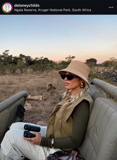 a woman sitting in the back of a safari vehicle