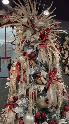 a christmas tree decorated with ornaments and ribbons