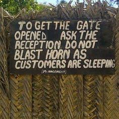 a sign on a fence that says to get the gate opened ask the reception do not blast horn as customers are sleeping