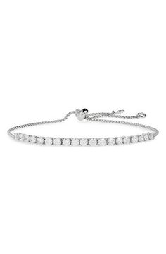 Reimagined as an on-trend slider style, this modern take on the classic tennis bracelet boasts signature shine with a line of round cubic zirconia. 1/8" x 2 3/8" charm Adjustable slide closure Gold plate or imitation-rhodium plate/cubic zirconia or glass Imported Unisex Jewelry, Tennis Bracelet, Chuck Taylor Sneakers, Sliders, Rhodium Plated, Cubic Zirconia, Platinum, Gold Plate, Jewelry Bracelets