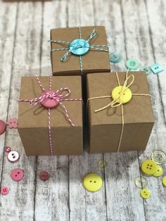 three brown boxes tied with twine and buttons