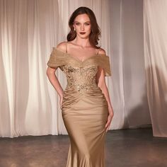 Indulge In Elegance With Our Fitted Satin And Lace Gown, Featuring A Luxurious Combination Of Fabrics That Exude Sophistication And Grace. The Off-The-Shoulder Accessory Adds A Touch Of Allure And Romance, Perfectly Framing Your Shoulders And Collarbone For A Breathtaking Look. This Gown Is Designed To Accentuate Your Curves With A Fitted Silhouette That Flatters Your Figure In All The Right Places. Fabric: Stretch Satin Length: Long Color: Gold Neckline: V-Neck Silhouette: Sheath Sleeve: Sleeve Gold And Champagne Mother Of Bride Gowns, Fitted V-neck Dress For Mother Of The Bride, V-neck Fitted Bodice Mother Of The Bride Evening Dress, Satin Mother Of The Bride Dresses, Gold Mother Of The Bride Dress, Mom Of The Groom Dresses, Satin Ruched Dress, Shoulder Accessories, Gold Evening Gown