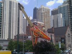 a giant guitar sign in the middle of a city