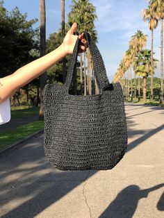 Any woman must have this bag for every fashionista.Whether you keeping it to yourself or gifting someone you care, it will be unforgettable. ✔️I made this beautiful bag from black natural paper rope which is organic cotton. ✔️The interior of the straw summer bag has a magnetic button. Suitable for use as shoulder bag, beach bag or party bag ✔️You can combine your clothes with a straw summer bag on summer days ✔️Handcrrafted in Turkey ✔️Hand-crocheted with care ✔️This bag is light weight yet dura Trendy Natural Canvas Shoulder Bag, Black Large Capacity Bucket Bag For Vacation, Black Bucket Bag With Large Capacity For Vacation, Eco-friendly Handheld Crochet Bag With Large Capacity, Trendy Handheld Crochet Bag, Packable Shoulder Bag, Trendy Large Capacity Crochet Bag For Beach Season, Trendy Rectangular Hobo Bag For Beach Season, Chic Large Capacity Bag For Beach Season