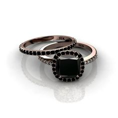 two engagement rings with black diamonds on them