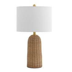 a wicker table lamp with a white shade