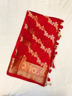 Showcasing a red colour Chiniya Silk saree, this saree is a masterpeice, hardwork of weavers are clearly visible in this, artistry of designer weaves to make the saree in checks pattern and fill it up with multicolour threads floral abstract,  This saree comes with a multiple colour contrasting Resham tassels.  Length: 6.5 mtr saree including 1mtr blouse peice Traditional Red Slub Silk Pre-draped Saree, Red Tussar Silk Pre-draped Saree With Motifs, Bollywood Style Tussar Silk Pre-draped Saree With Motifs, Traditional Tussar Silk Pre-draped Saree, Diwali Motifs Pre-draped Raw Silk Saree, Chanderi Pre-draped Saree With Motifs For Puja, Art Silk Pre-draped Saree With Pallu For Rituals, Diwali Pre-draped Saree With Dupatta For Rituals, Traditional Designer Pre-draped Saree