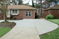 a driveway in front of a brick house