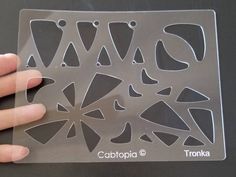 a person holding onto a clear plastic cutting board