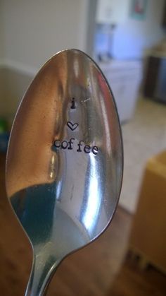 a close up of a spoon with the word coffee written on it's side