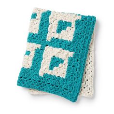 two blue and white crocheted squares on top of each other