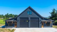 a large garage sits in the middle of a field