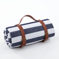 a blue and white striped blanket with leather straps