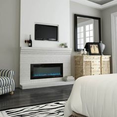 a bedroom with a bed, chair and fireplace