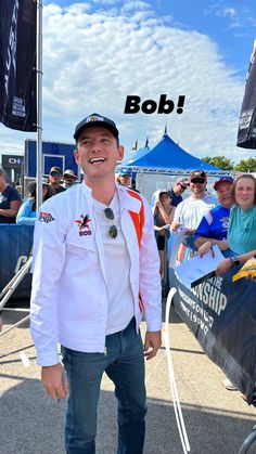 a man standing in front of a boat at an event with the caption bob