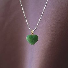 Beautiful heart jade necklace, Gorgeous translucent green. The pendant is made from nephrite jade mined from British Columbia, Canada. We currently only have the gold plated jump ring in stock. The pendant comes with a stainless steel jumpring. Option to buy sterling silver chain necklaces. Jade brings harmony and contentment to the wearer. In Asian cultures, Jade is revered as the good luck stone which can bring happiness, wealth, and friendship. 15mm x 15mm x 4.85mm 4.6 grams Dainty Heart Pendant Necklace For May Birthstone, Delicate Green Charm Necklace As Gift, Green Heart Beads Necklace For Gift, May Birthstone Heart Pendant Necklace, Green Heart Necklace For Gift, Green Dainty Jewelry For Valentine's Day, Heart Shaped May Birthstone Necklace With Heart Charm, Green Double Heart Jewelry For Valentine's Day, Elegant Green Heart Necklace For Gift