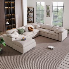 a living room with a large sectional couch in the center and lots of pillows on the floor