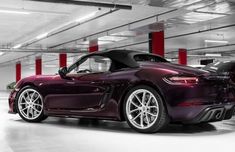 a purple sports car parked in a parking garage