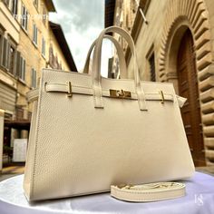 This bag has been made of the best genuine leather by local master crafters of Florence in Italy, designed for women who only accept premium Italian quality and luxury leather bags and modern Italian fashion. . Size: Height: 24 cm / 9.45 inches Width: 34 cm / 13.39 inches Depth: 14 cm / 5.51 inches . The story of this bag: In the heart of Florence, amidst the cobblestone streets and Renaissance architecture, lies a workshop where tradition meets innovation. It is here that skilled artisans craft Business Gold Bag With Textured Leather, Elegant Textured Leather Rectangular Bags, Elegant Rectangular Textured Leather Bags, Gold Satchel With Gold-tone Hardware, High-end Gold Satchel With Gold-tone Hardware, Gold Textured Leather Business Bag, Luxury Gold Bag For Business, Luxury Gold Business Bag, Elegant Textured Leather Box Bag For Everyday Use