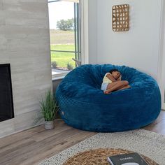 a person sleeping in a large blue bean bag chair