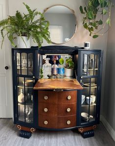 an antique cabinet with glass doors and drawers is displayed in the corner of a room