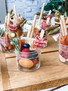 small jars filled with food on top of a wooden table