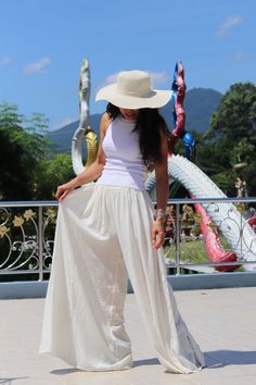 All items are shipped to Thailand Post . Free upgrade to D.H.L Express when you buy 2 or more items . The USA only. Please leave a phone number with orders . Made in 100% cotton soft , light and very comfy . These bell bottom pants have a cute design .They allow you to adjust the bottom of the hemline with 4 ties on the inside of the leg .Tighten the ties to create a draped look , tie loosely for a bell-bottom hemline. A fantastic flare of 50''inches. The pants are half lined with an elastic wai Summer Stretch Wide Leg Parachute Pants, White Stretch Parachute Pants For Summer, Beige Stretch Harem Pants For Summer, High Waist Cotton Harem Pants For Beach, Stretch Wide-leg Parachute Pants For Summer, Fitted Solid Color Parachute Pants For Summer, Bohemian Style High Waist White Wide Leg Pants, Stretch Straight Parachute Pants For Summer, Stretch Summer Parachute Pants