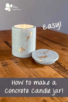 a candle sitting on top of a wooden table next to a plate with gold paint