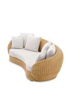 a wicker couch with white pillows on the top and bottom, in front of a white background