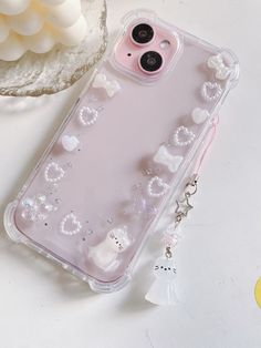 a clear case with white flowers and hearts on it