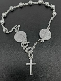 Stylish 925 Sterling Silver rosary bracelet, Catholic Rosary bracelet with Saint Benedict, 4mm sparkle ball chain, a perfect gift for her or him with diamond cuts. These rosaries are stamped 925 for authenticity and are fully adjustable.  We proudly stand behind the quality of our products and prioritize your satisfaction above all else. If, for any reason, you are not completely satisfied with your purchase, we offer hassle-free returns with full refunds of the purchase price. Your happiness is Nickel-free Silver Cross Rosary Bracelet, Spiritual Silver Charm Bracelet With Cross, Spiritual Silver Cross Charm Bracelet, Sterling Silver Rosary Bracelet Gift, Silver Rosary Bracelet With 8mm Beads As Gift, Sterling Silver Rosary Bracelet With Round Beads, Sterling Silver Rosary Bracelet With Round Beads As Gift, Adjustable Hypoallergenic Silver Rosary Bracelet, Adjustable Silver Cross Rosary Bracelet