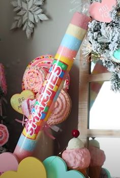 there is a large candy stick in the middle of many other candies and decorations