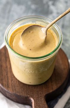 a spoon in a jar filled with peanut butter