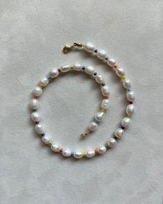 Authentic freshwater pearl Length: 15 inches Pearl: 5x7mm round pearl Glass beads: 3mm multicolor beads Lock: lobster clasp, gold plated stainless steel Multicolor Pearl Drop Necklaces With Round Beads, Multicolor Round Beads Necklace With Pearl Drop, Rondelle Pearl Necklace With Pearl Charm As Gift, Beaded Rondelle Pearl Necklace, White Pearl Beaded Necklaces In Rondelle Shape, White Pearl Beaded Necklace In Rondelle Shape, Everyday Pearl Necklace With Tiny Round Beads, Everyday Pearl Necklace With Tiny Beads, Everyday Pearl Drop Beaded Necklaces