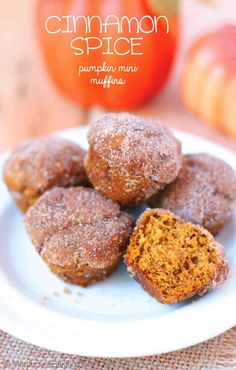 cinnamon spice pumpkin mini muffins on a white plate with an apple in the background